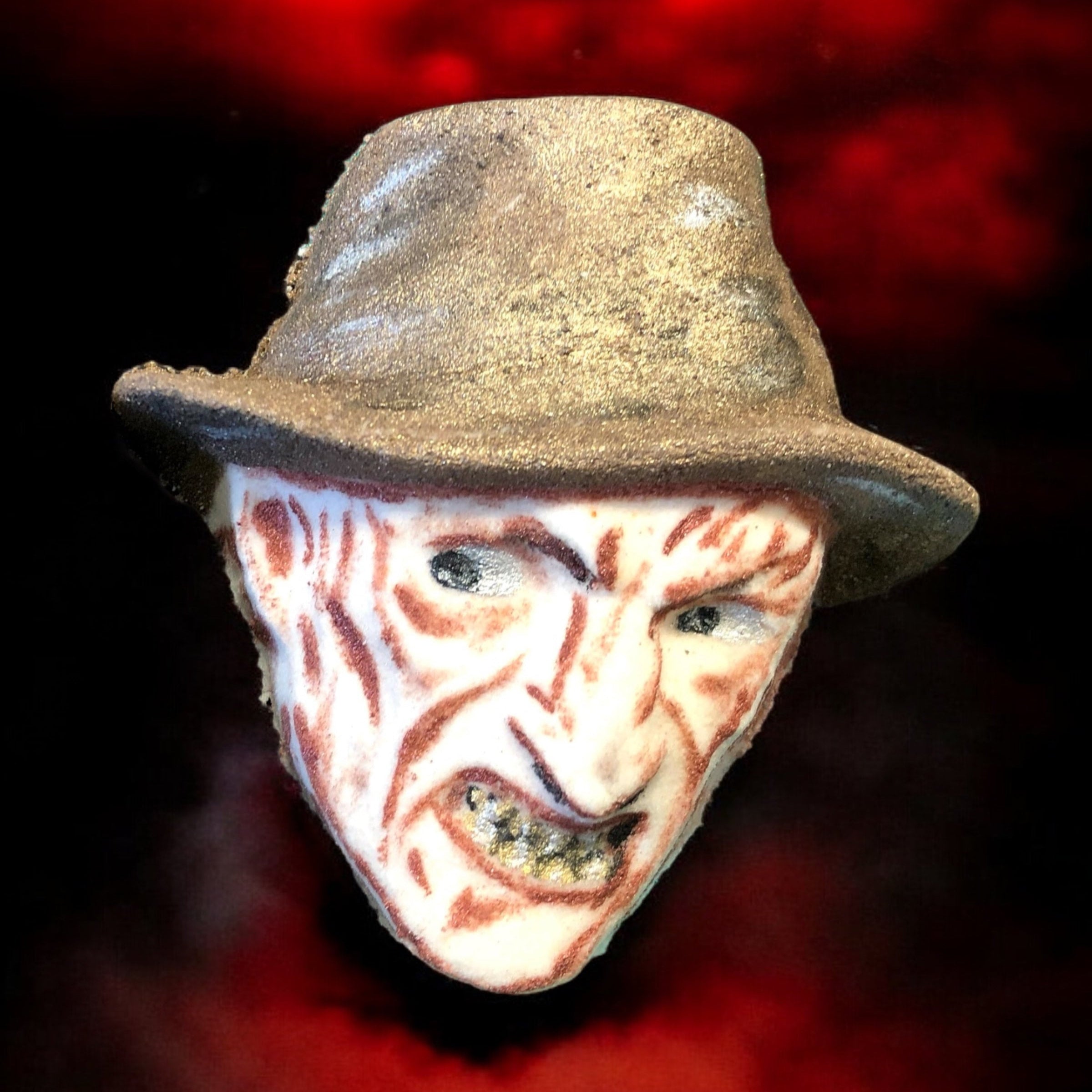 Mask with a distressed hat against a red and black background